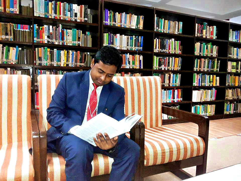 Dr Subodh Kumar reading book in LBSNAA Library, Mussoorie